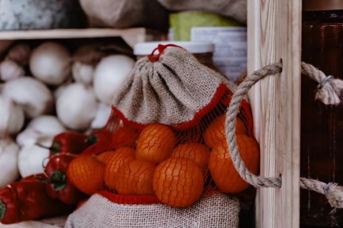 orange fruits on white and red textile